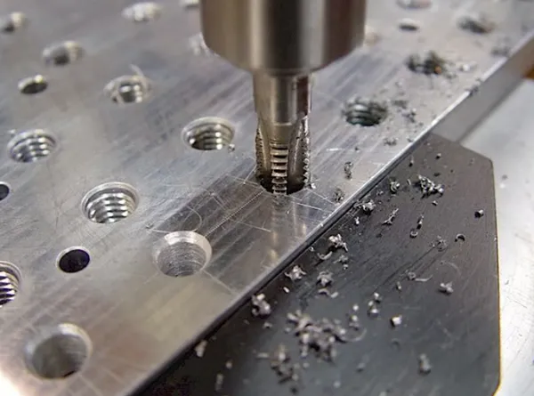 A threaded hole in a machined part