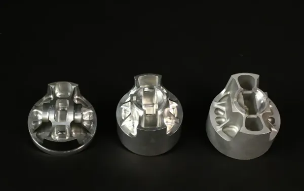 The bottom of the blank piston (far right) is sandblasted to eliminate stress concentrations during machining